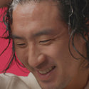 Man lathering his hair with thickening shampoo