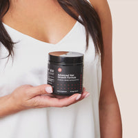 Short clip showing a woman opening the jar of Advanced Hair Growth Formula and pouring the content in her hand.