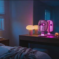 Face Mask Pro attached to the Glow Stand on top of a bedside table, with the Glow Stand glowing in different colors.