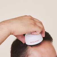 Short clip of a man rolling the derma roller in his scalp.