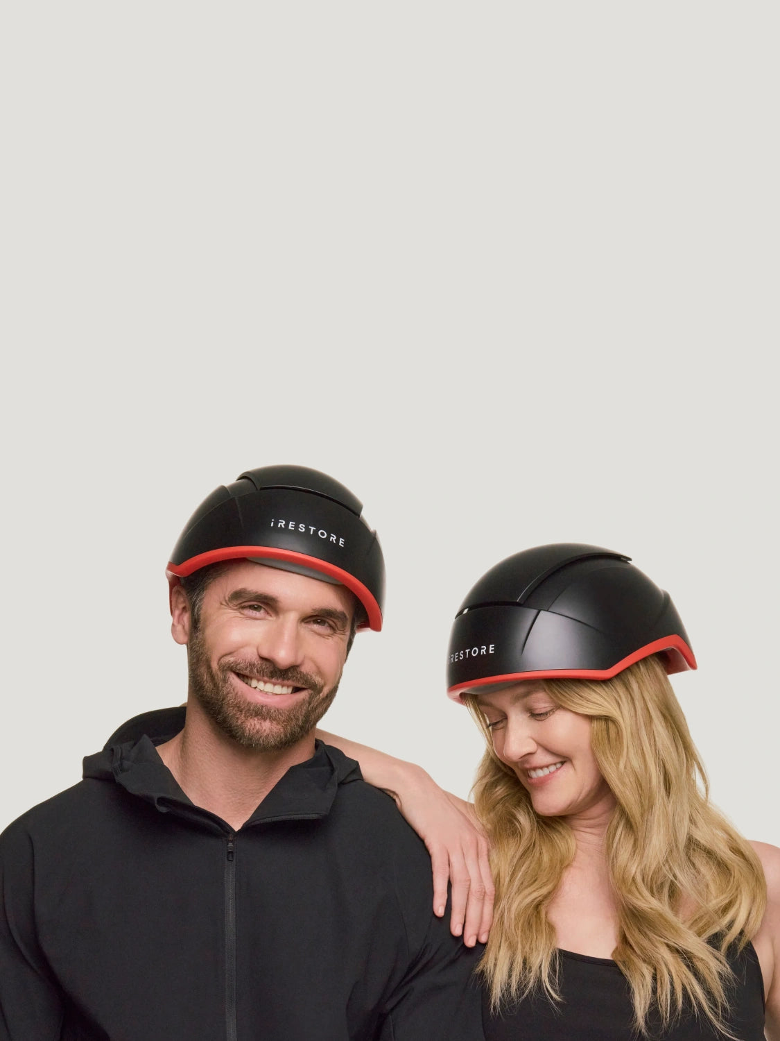man and woman smiling, wearing irestore elite