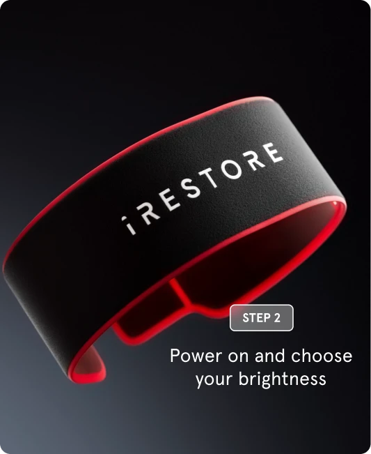 "Step 2" showing the exterior of a black iRESTORE sculpt belt with a red border. The text overlay reads: "Power on and choose your brightness."