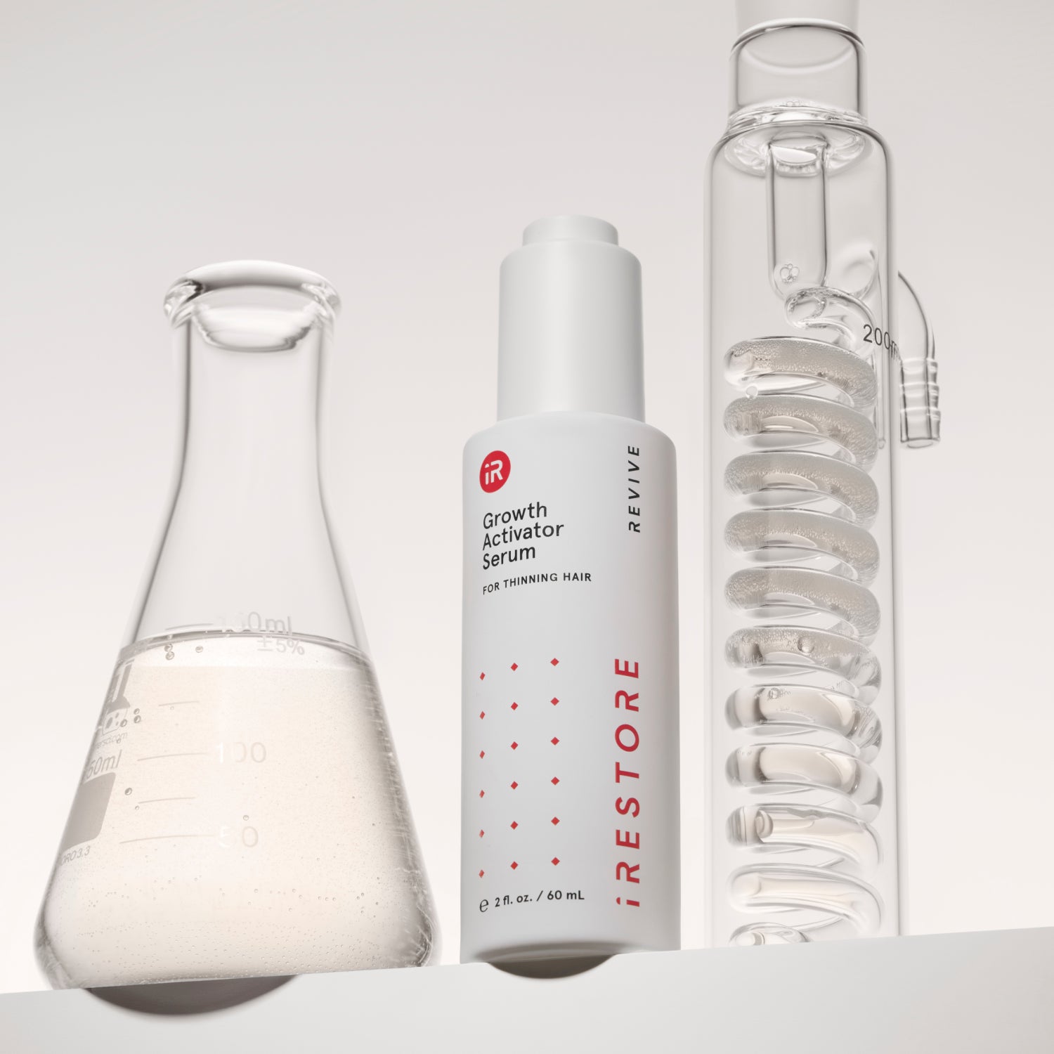 growth serum bottle in between two laboratory flasks