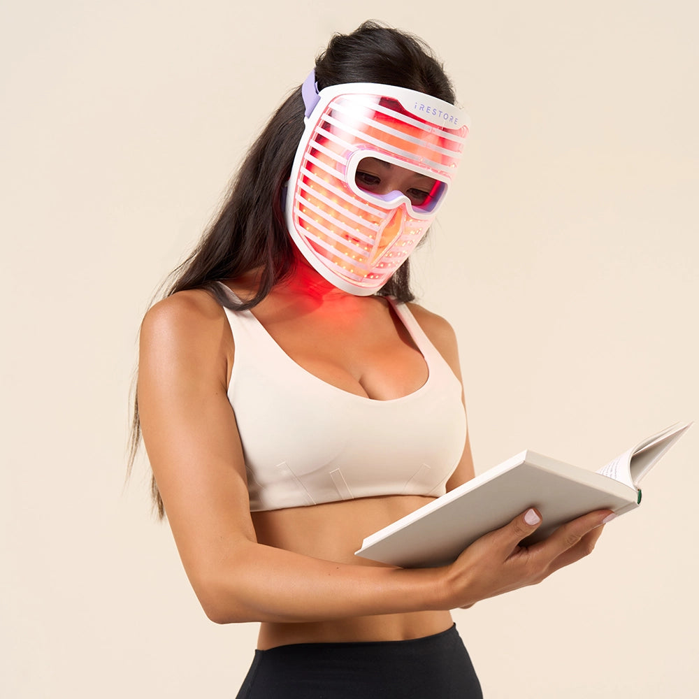 Model wearing iRESTORE Face Mask reading book