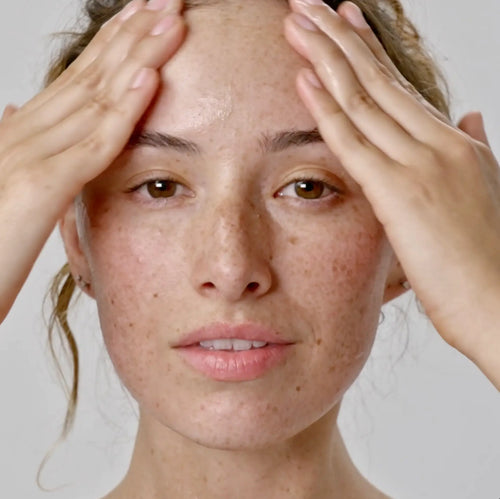 woman touching her forehead