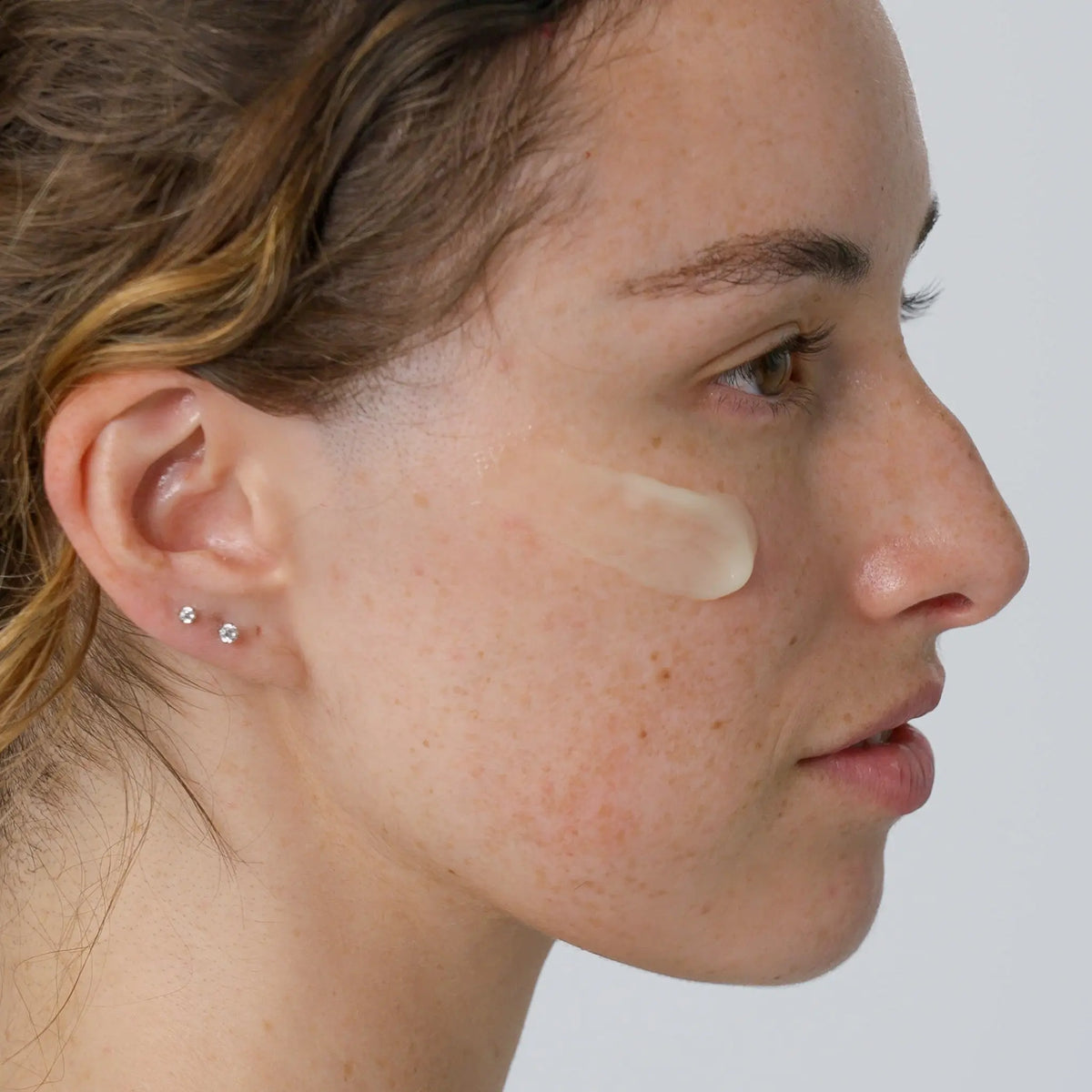 side view of woman with vitamin c serum on her face