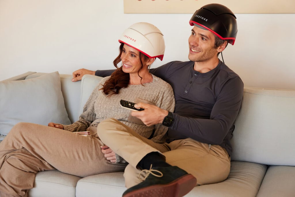 Woman wearing the professional device sitting beside a man wearing the elite device.