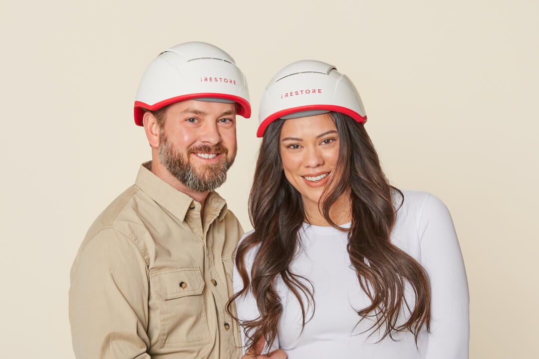 Image shows a man and woman standing beside each other while wearing the Professional Device.