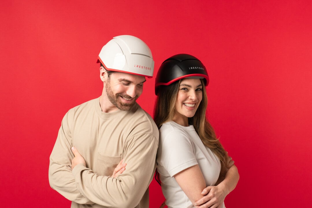 Image shows a man wearing the Professional device and a woman wearing the Elite device.
