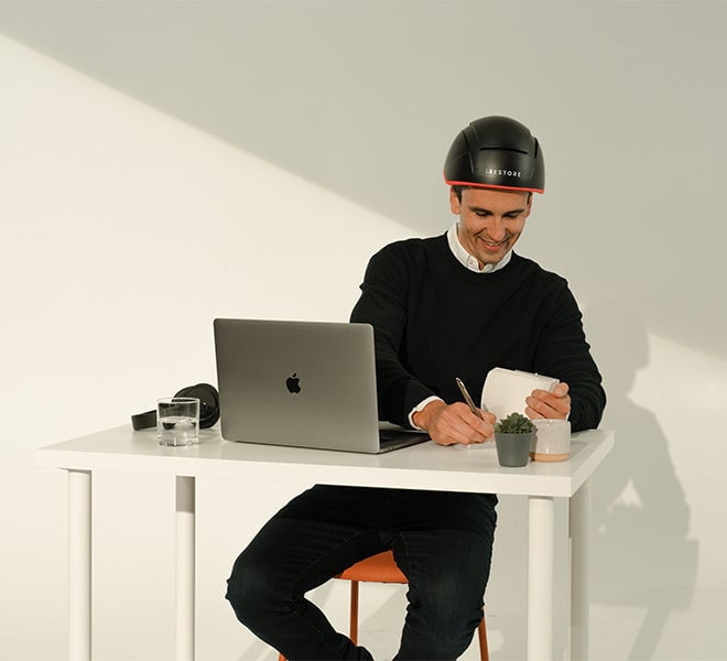 Image of a man working from home while wearing the Professional device.