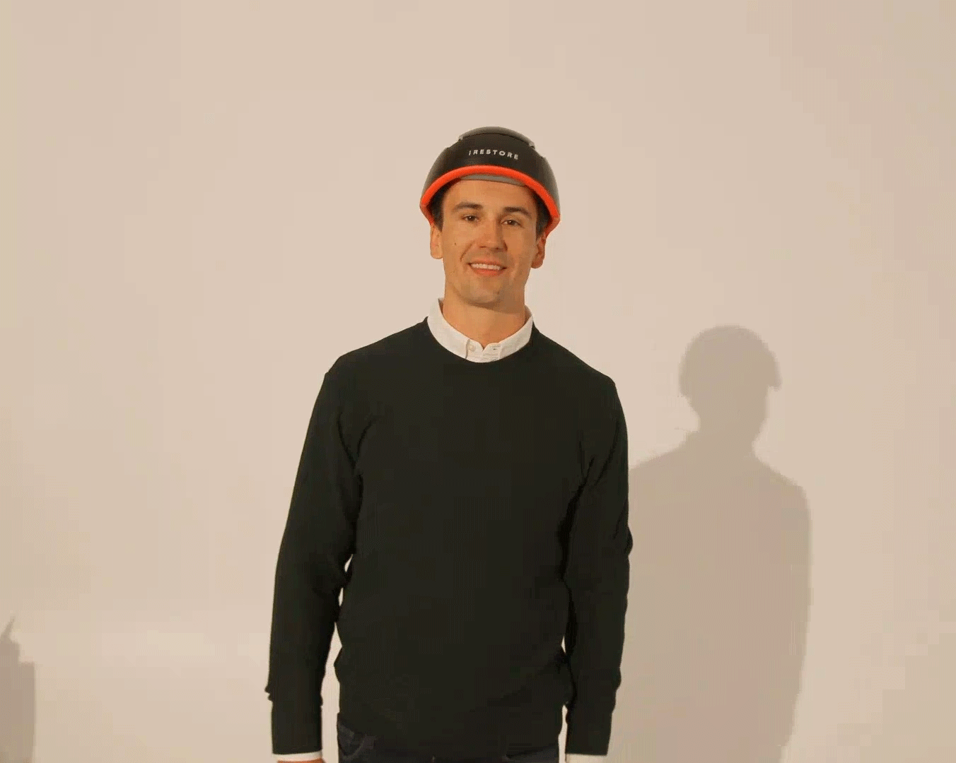 GIF of man walking while wearing the iRESTORE Elite hair device.
