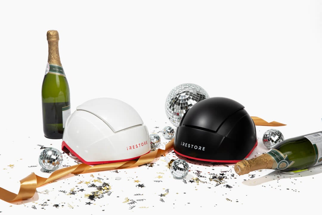 Image shows the Elite and Professional device with small disco balls, gold ribbons, champagne bottles and scattered confetti around it.