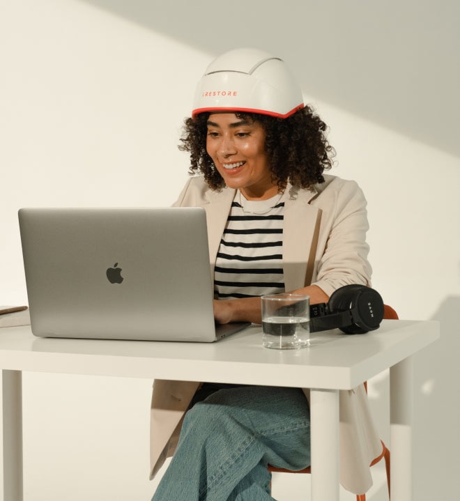 Image of a woman working from home while wearing the Professional device.