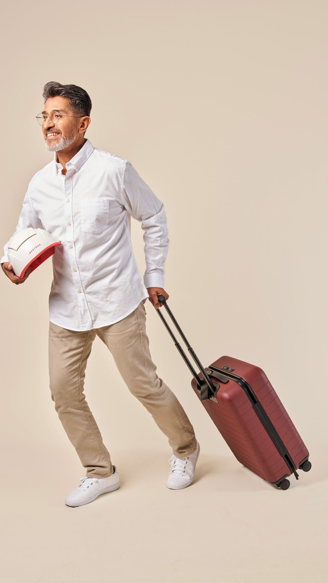 Image showing a mature man pulling his luggage while holding the Professional device in his other hand.