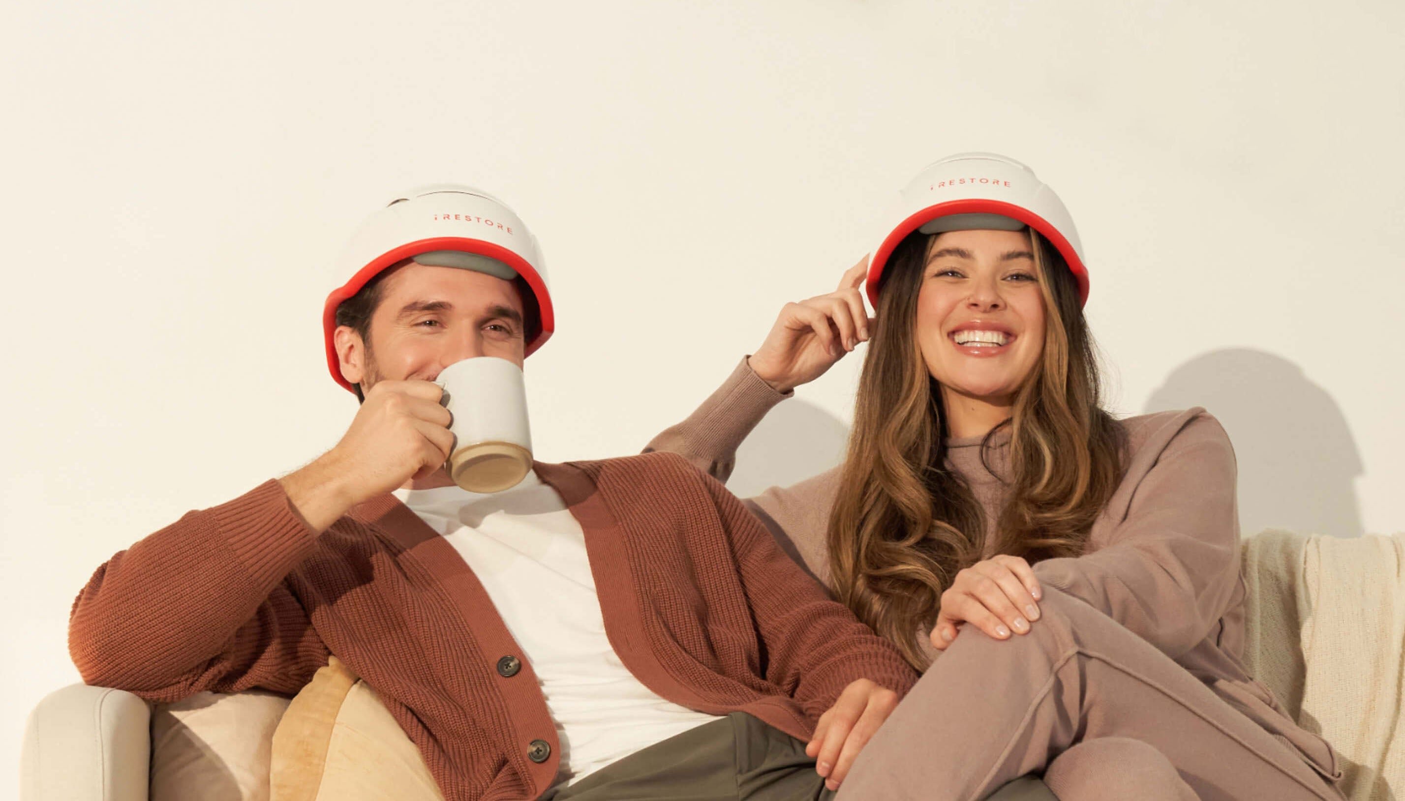 Image banner of a man and woman wearing the Professional Device sitting on a couch.
